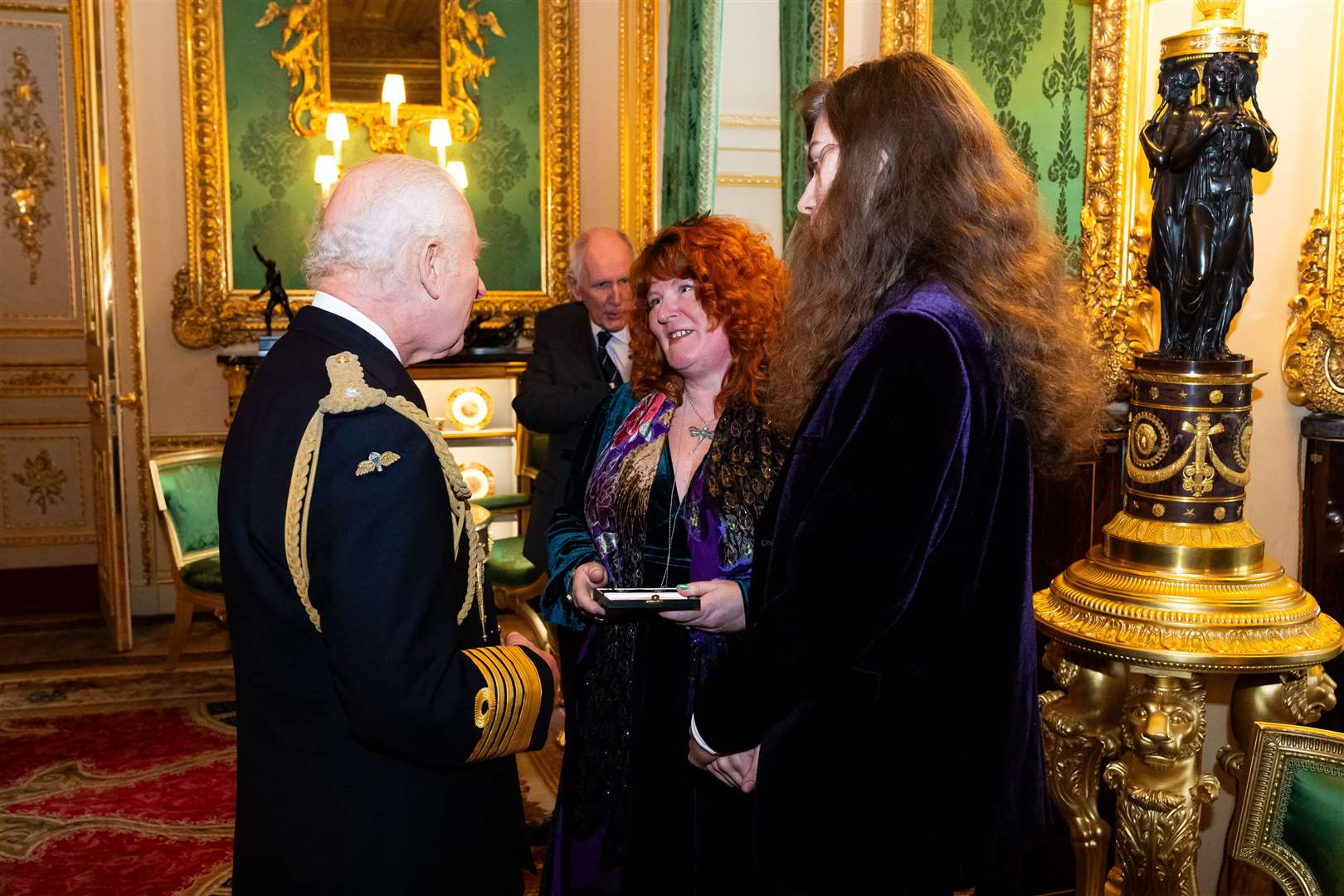 Charles presents an Elizabeth Emblem to Rebecca Lombard-Earl, for firefighter Fleur Lombard of Avon Fire and Rescue during the inaugural presentation ceremony at Windsor Castle (Aaron Chown/PA)