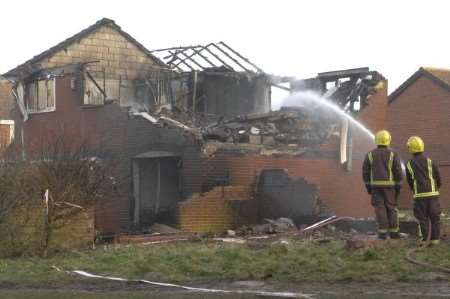 Firefighters deal with the aftermath of last month's disaster