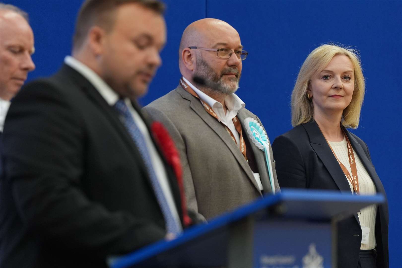 Liz Truss watches as the announcement in Norfolk South West is delivered (Jacob King/PA)