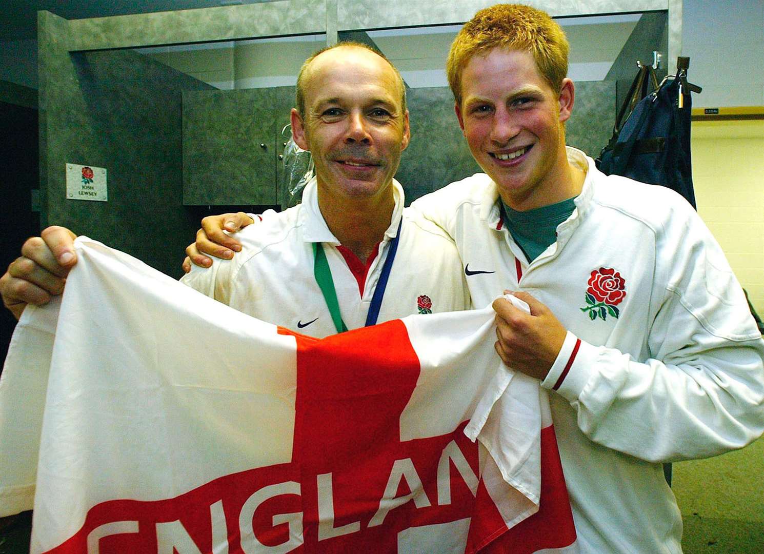 England coach Clive Woodward is congratulated by Harry as they celebrate after England’s Rugby World Cup win over Australia (PA)