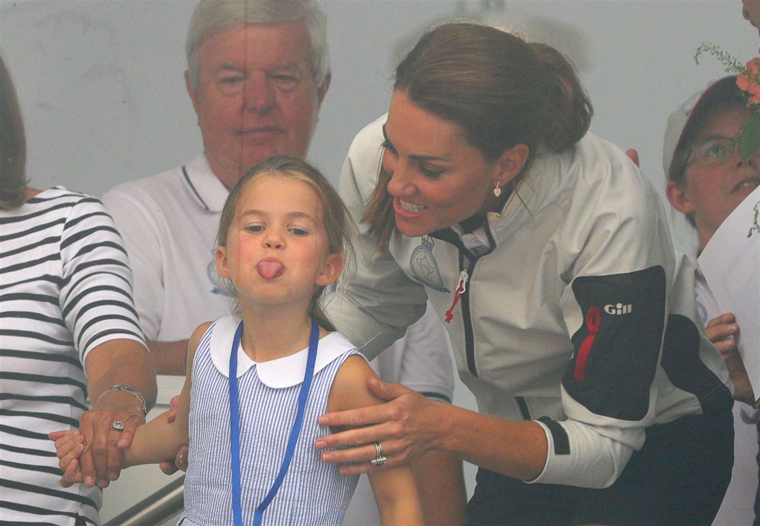 Charlotte pokes her tongue out as she looks through a window at the prize-giving after the King’s Cup regatta at Cowes on the Isle of Wight (Aaron Chown/PA)