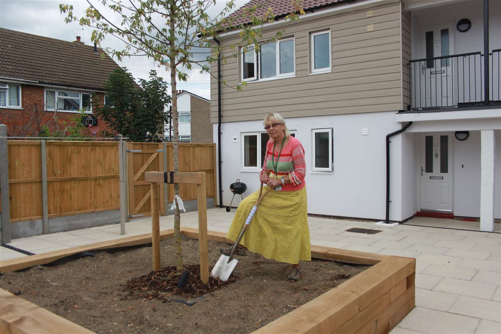 Ashford Borough Council deputy portfolio holder for housing, Cllr Aline Hicks, puts the finishing touches to some tree planting