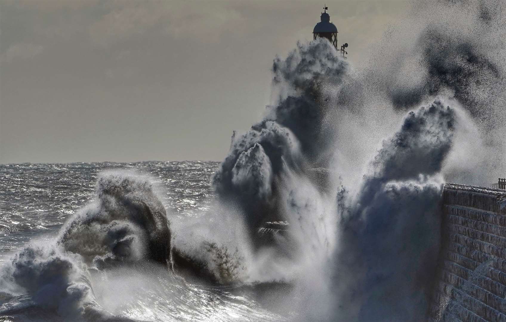 Waves crash against Tynemouth Lighthouse on the north-east coast (Owen Humphreys/PA)