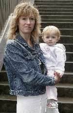 Sonya Daniels and 18-month-old daughter Hannah at the site where the handles of her pushchair broke. Picture: PETER STILL