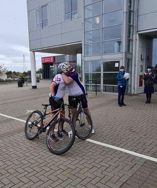 Andrew Unwin and his dad Derek share an emotional embrace after completing the challenge