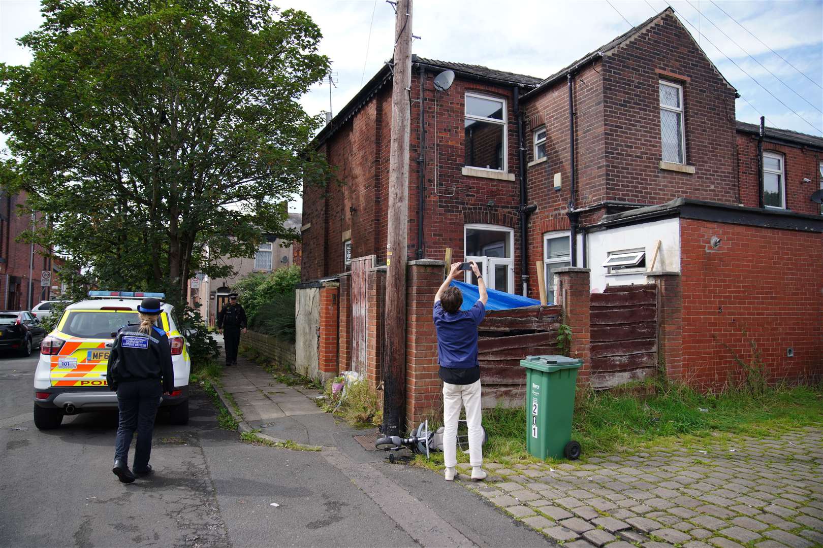 Police officers outside Donald Patience’s property on Ainsworth Road in Radcliffe, Greater Manchester (Peter Byrne/PA)