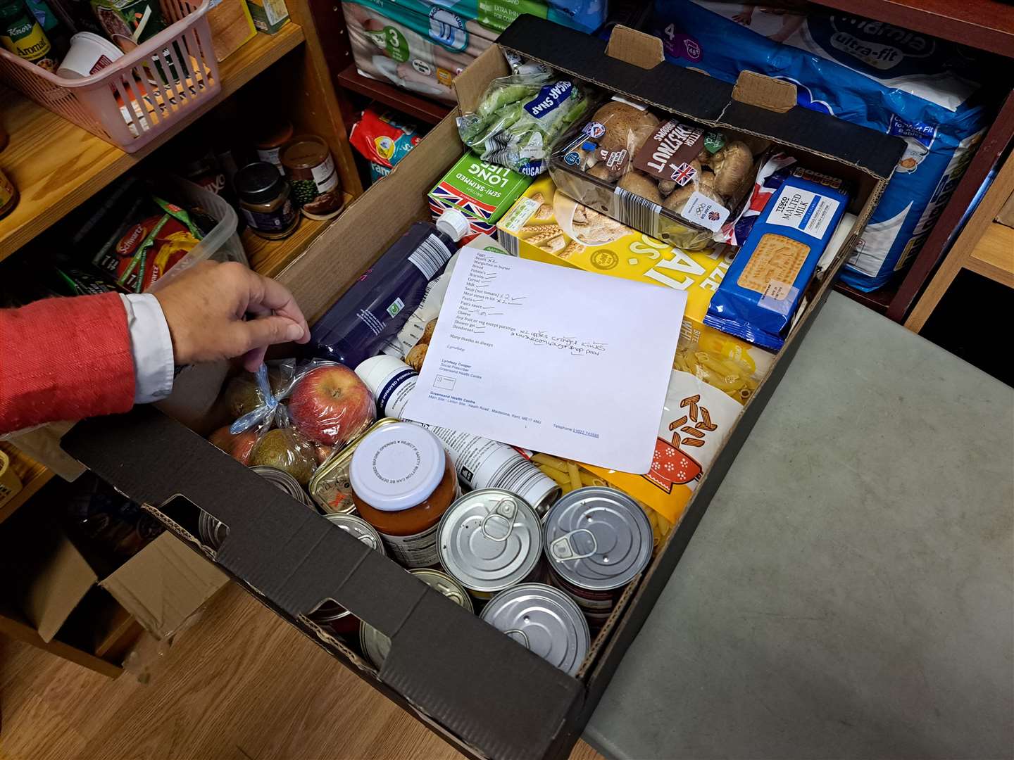 Inside the MADM HQ in Church Street - a food box is prepared