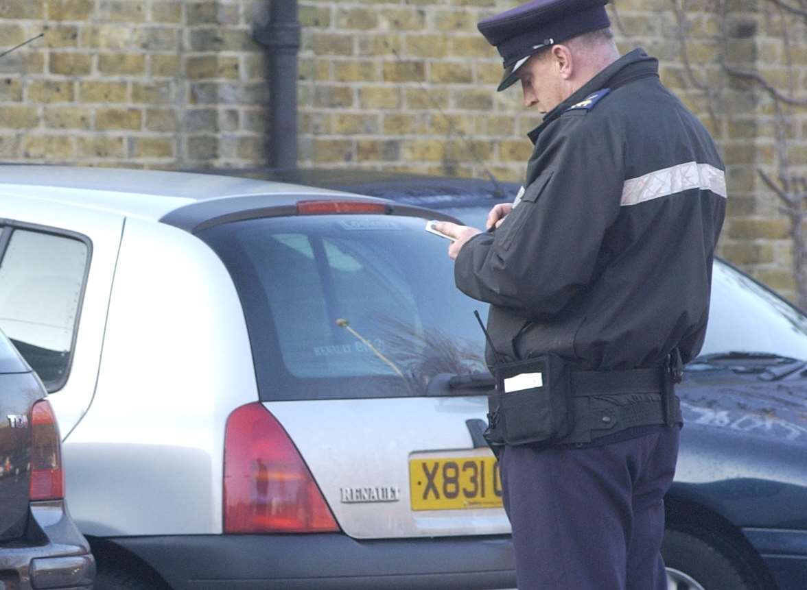 Traffic warden at work. Stock picture