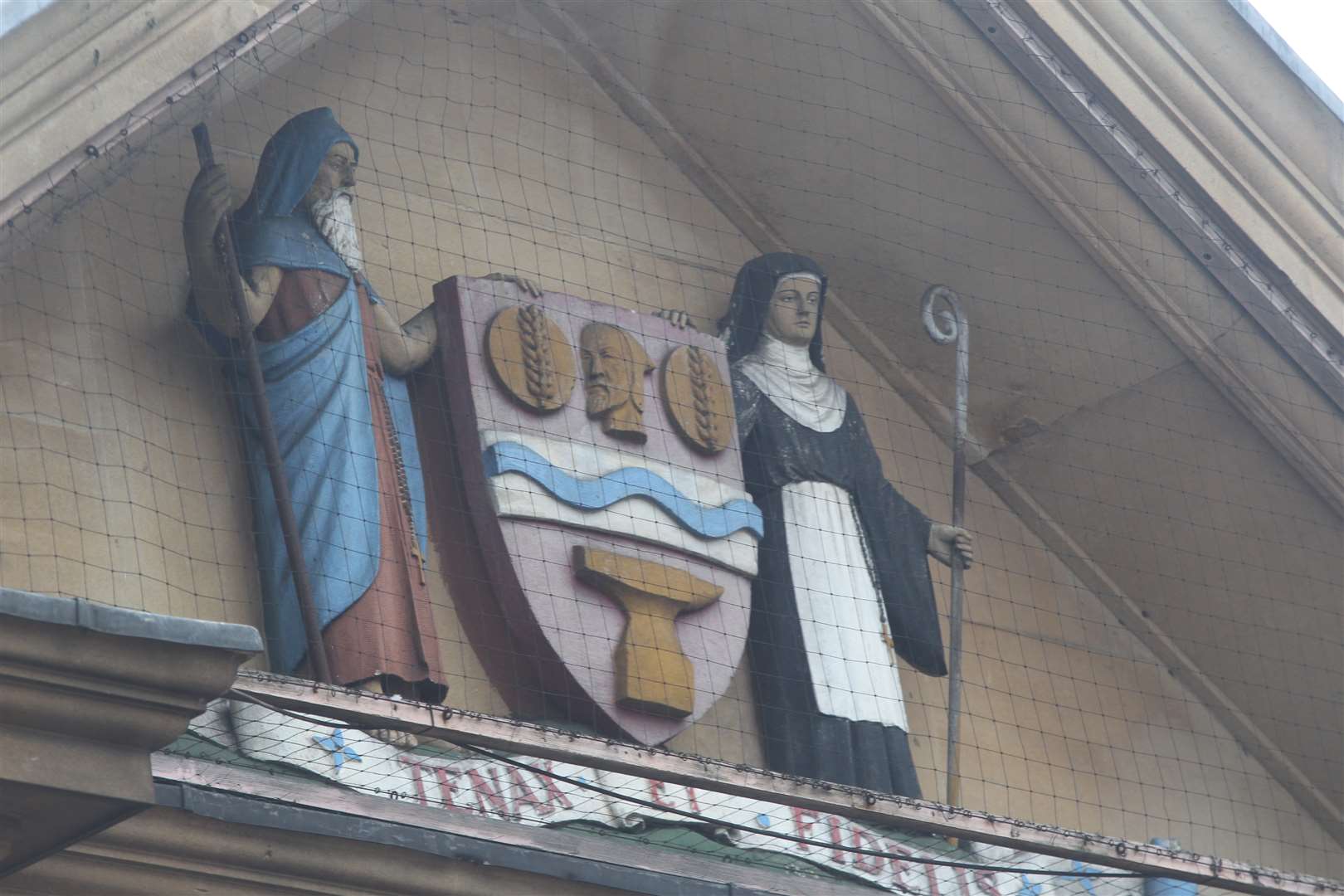 From which town's museum are these figures looking down on you?