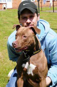 Phil Akers and his dog Koojo, who bit off the finger of a postman who put his hand through the letterbox.