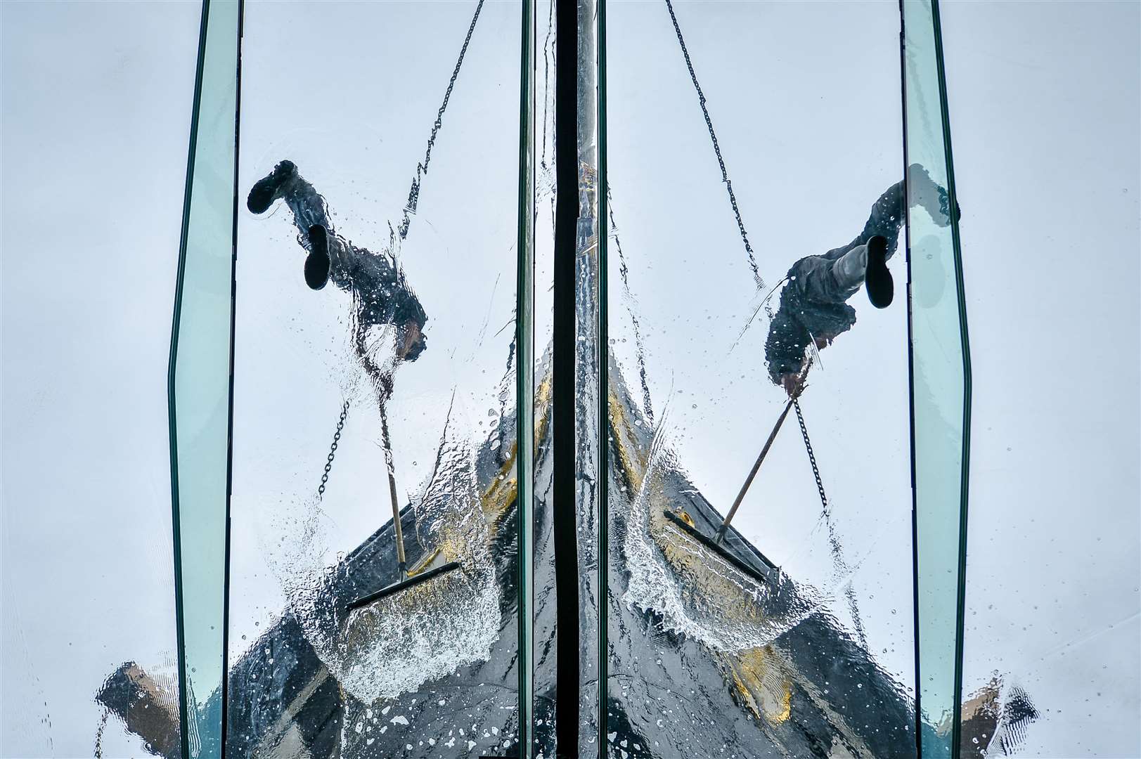 Staff clean the surface of the glass sea which surrounds the ship (Ben Birchall/PA)