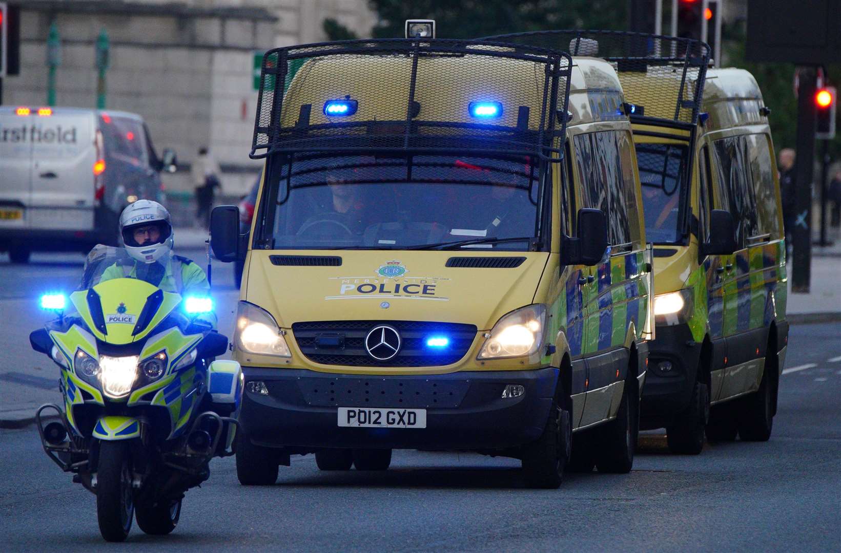 Police motorcycles block the road to other traffic as a vehicle carrying Thomas Cashman arrives at Liverpool Magistrates’ Court (Peter Byrne/PA)