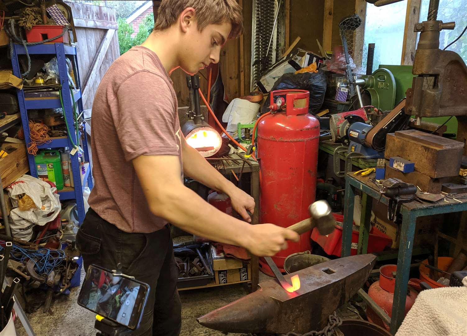 Jacob Shafe filming a YouTube video to demonstrate his work, which he sells at tabletop markets and online