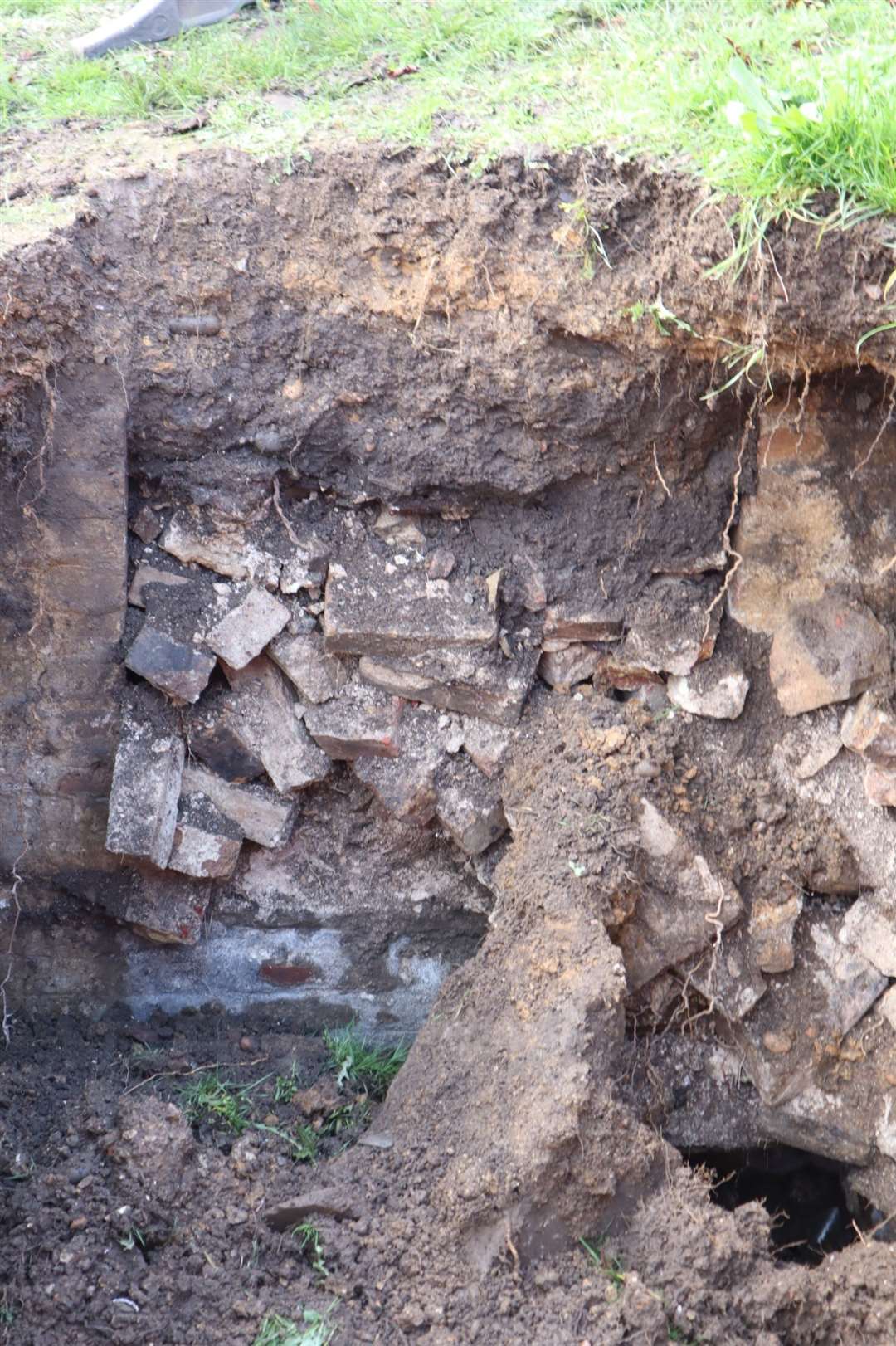 A gaping hole has appeared in the graveyard of Minster Abbey on Sheppey. Could it be a long lost tunnel or an old tomb?