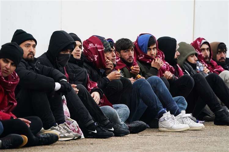 Many wrapped themselves in blankets to try and keep warm amid the cold weather. Picture: (Gareth Fuller/PA)