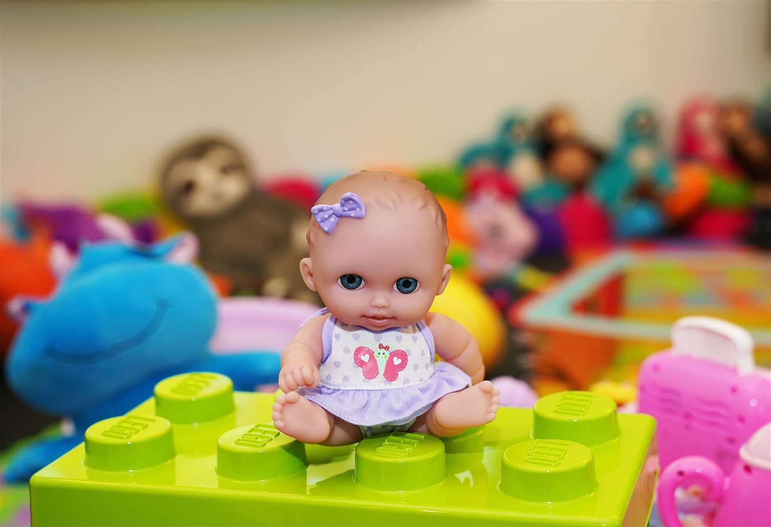 A doll sits among other toys in a welcome room at the new processing facility (Brian Lawless/PA)