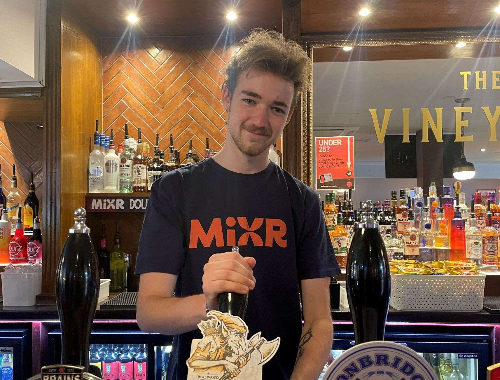 Bartender Harry Kelly, 19, is back to pouring pints in The Vineyard pub in West Street, Sittingbourne, after its makeover. Picture: Joe Crossley