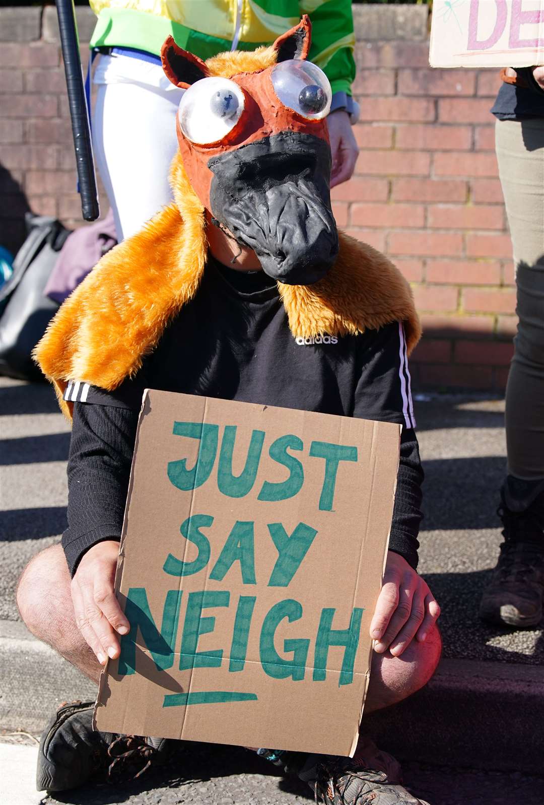 An activist outside the gates ahead of day three of the Randox Grand National Festival at Aintree Racecourse (Peter Byrne/PA)