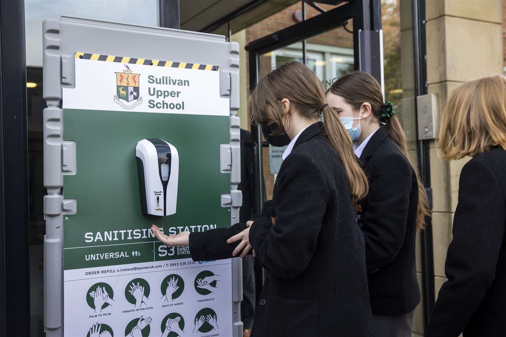 Pupils use a hand sanitisation station at Sullivan Upper (Liam McBurney/PA)