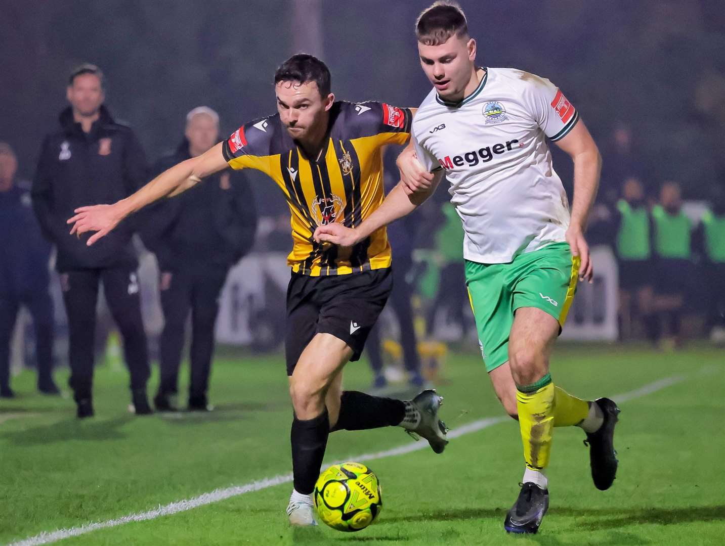 Folkestone forward Dan Smith battles for the ball - before being red-carded - with Dover defender Luca Cocoracchio, as Whites won the Isthmian Premier derby 1-0 on Tuesday. Picture: Helen Cooper