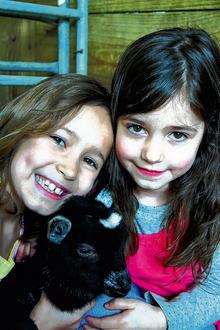 Daisy Hatswell, eight, from Luddenham and Lois Collingwood, five, from Faversham with Paula the kid at Farming World