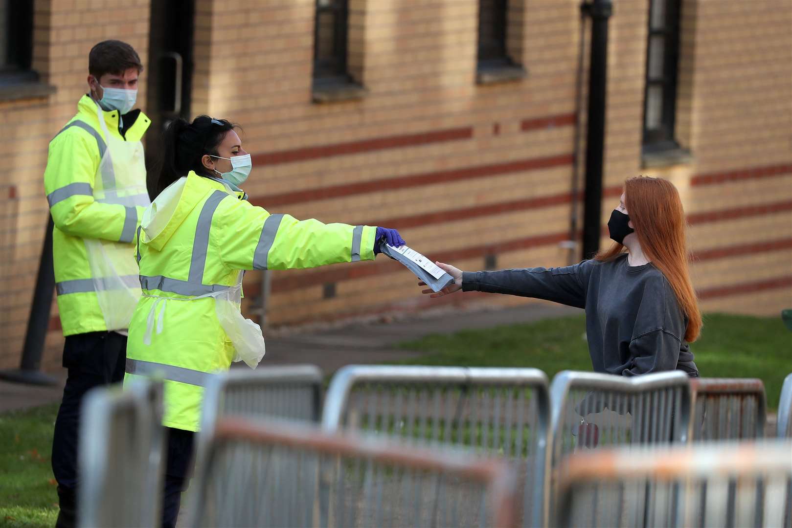 Testing kits being handed to students at Murano Street (Andrew Milligan/PA)