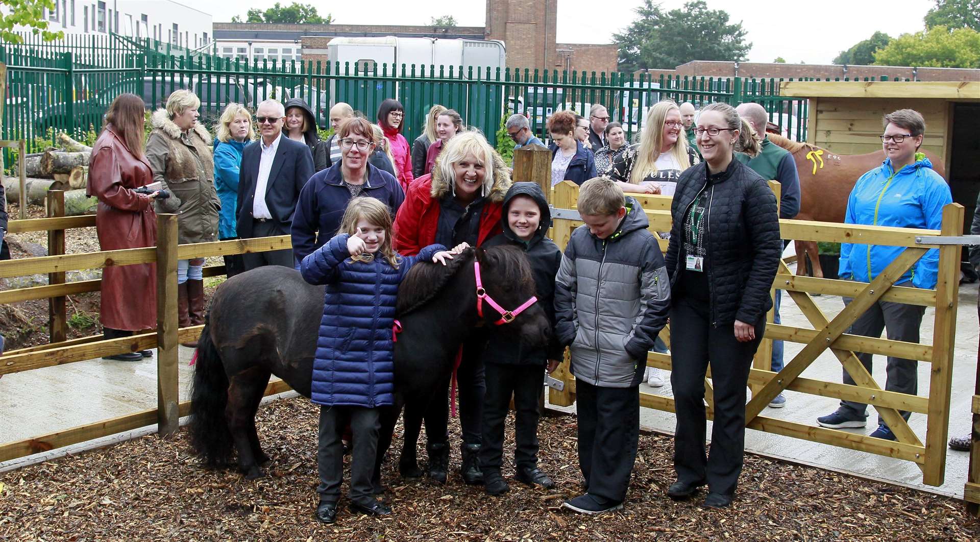 Volunteers have built stables at the school visited today by ponies from LuLu Pony Parties, pictured Ellie 8, Joe 8 and Raymond from Woodpecker class with volunteers and parents and LuLu the pony.Picture: Sean Aidan (11918561)