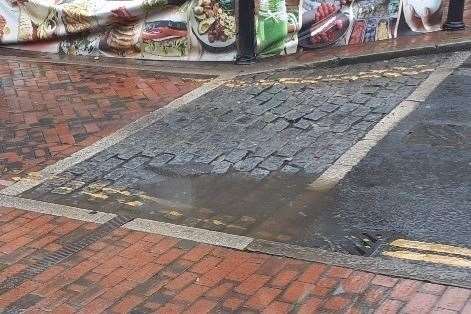 A puddle covering the cobblestones in Sittingbourne High Street. Picture: Ken Rowles