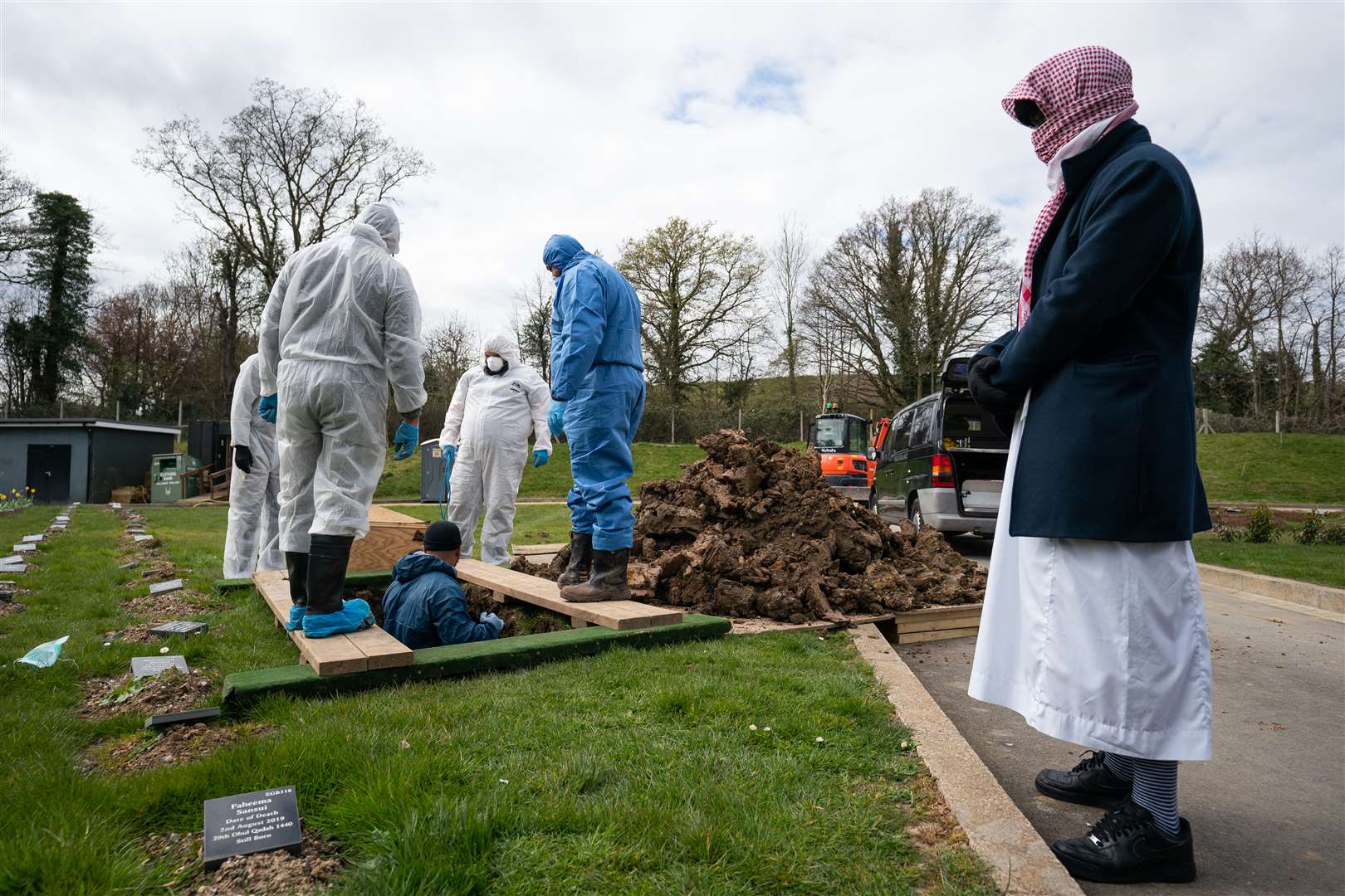The coffin of 13-year-old of Ismail Mohamed Abdulwahab is lowered into the ground at the Eternal Gardens Muslim Burial Ground at Chislehurst (Aaron Chown/PA)