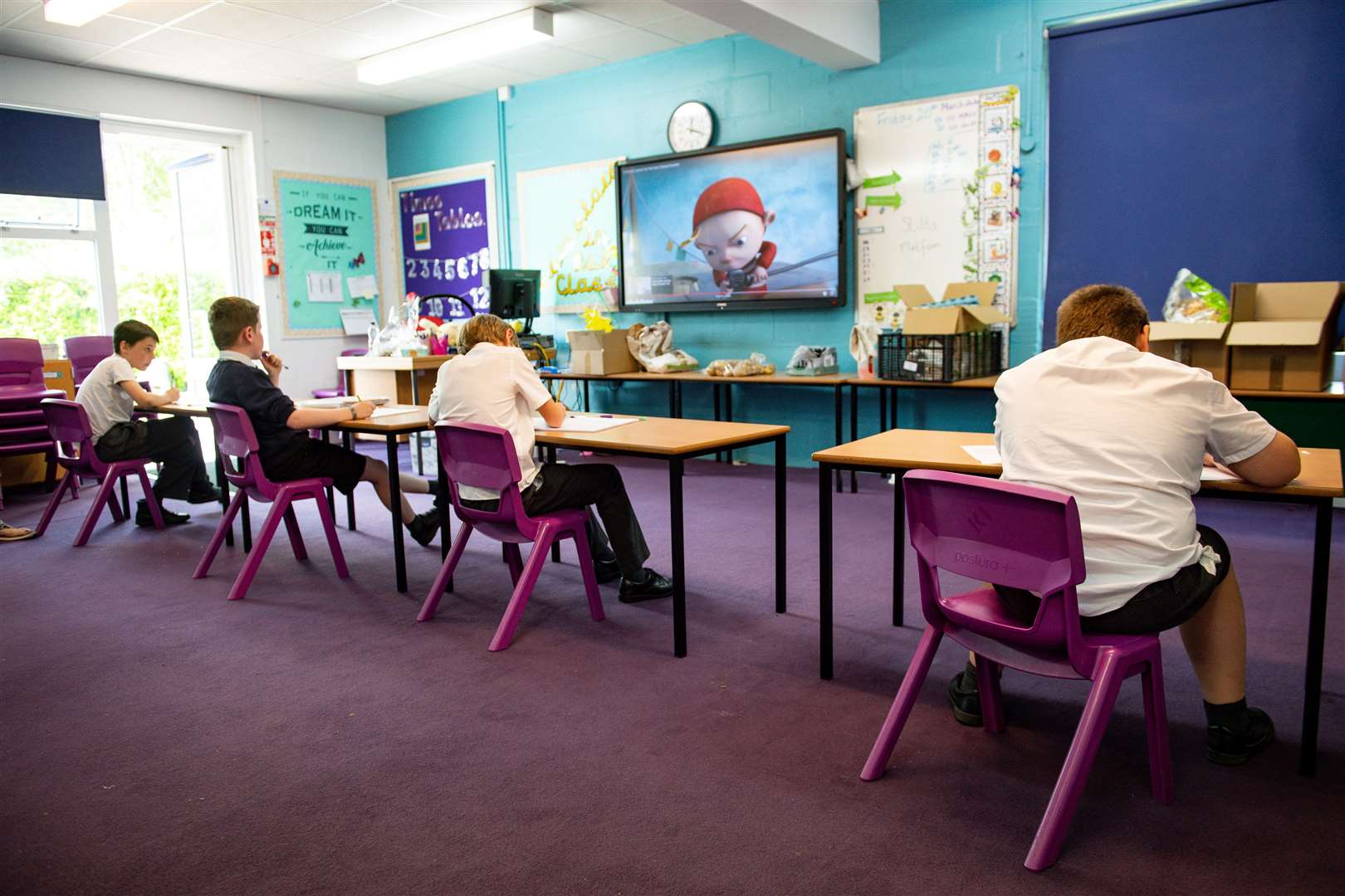 Children of essential workers socially distance whilst in lesson at Kempsey Primary School in Worcester (Jacob King/PA)