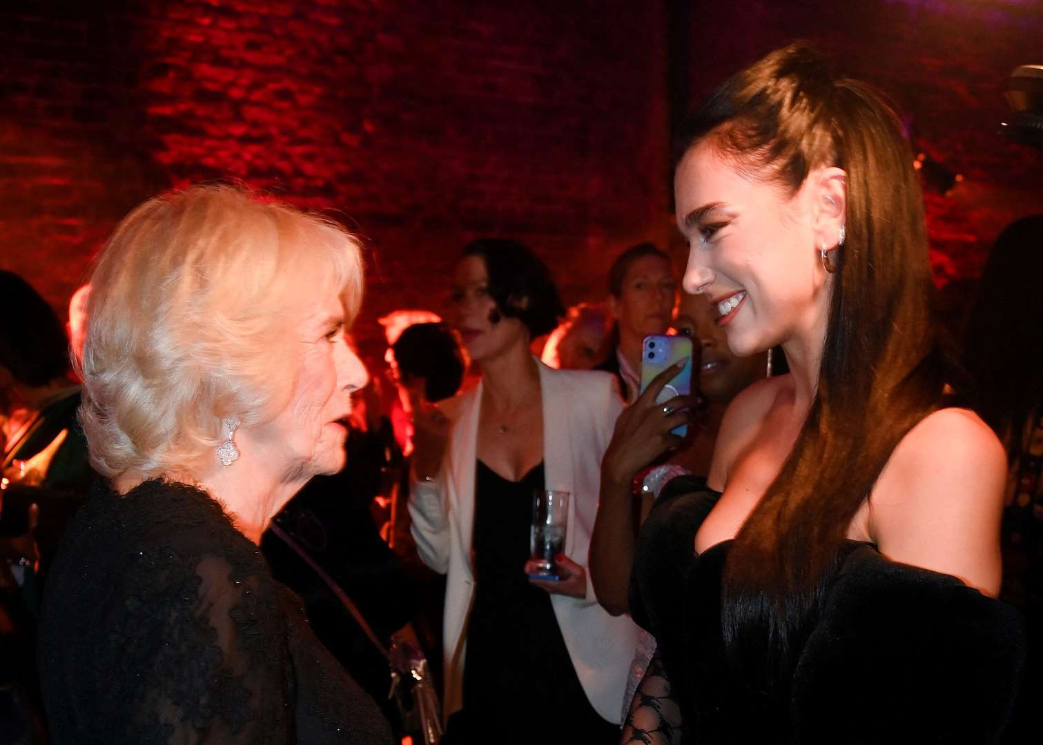 Camilla with Dua Lipa (Toby Melville/PA)