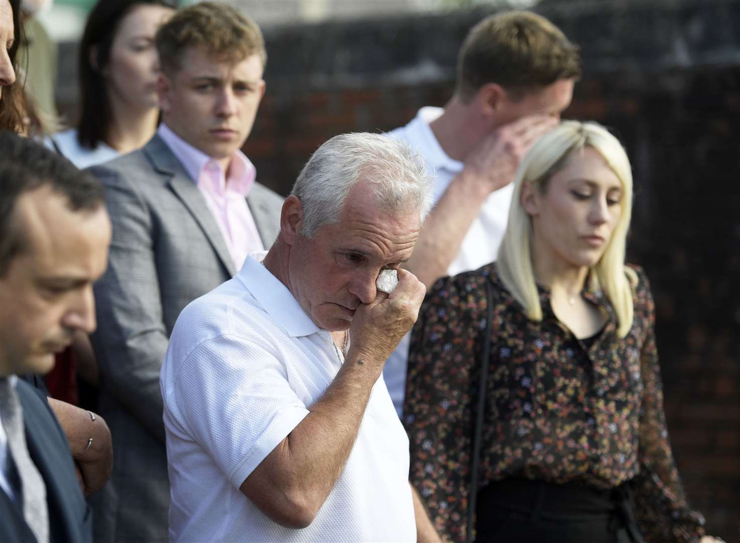 Julia's husband Paul James leads tributes outside Canterbury Crown Court, alongside Julia's son Patrick Davies and daughter Bethan Coles. Picture: Barry Goodwin