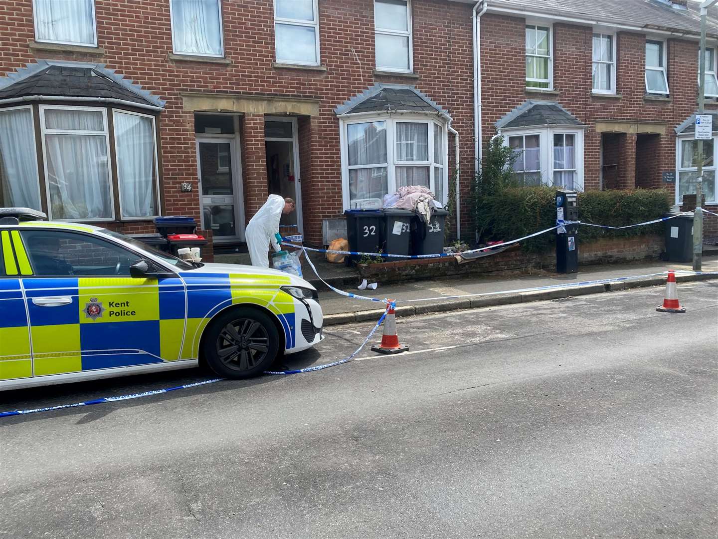 Forensics continue to investigate in St Martin's Road, Canterbury, on Sunday after a woman was charged with murder following the discovery of human remains at a property