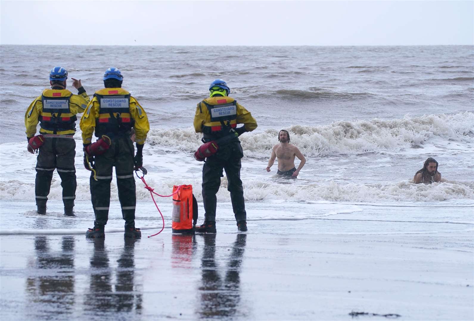 A coastguard search and rescue team ask a group of swimmers to come out of the sea in New Brighton, Merseyside (Peter Byrne/PA)