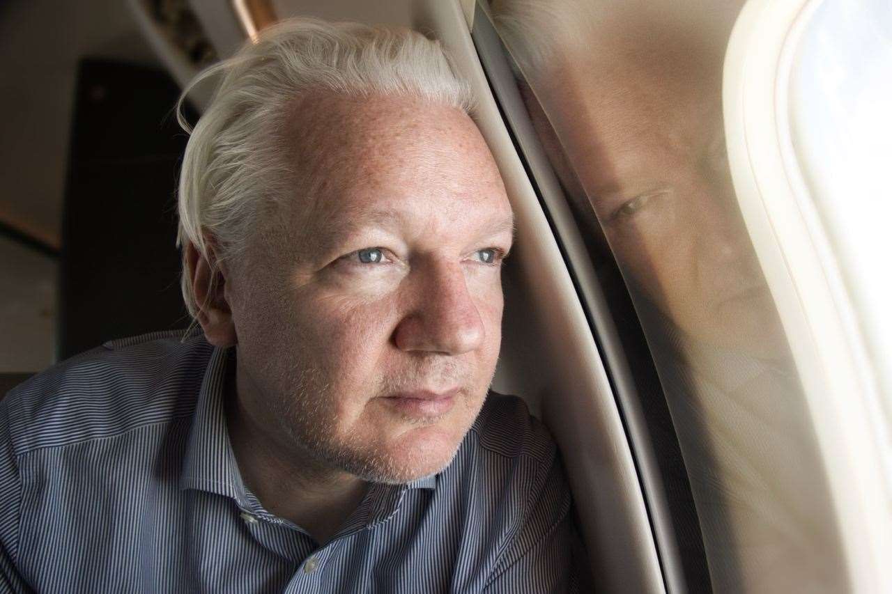 Julian Assange on board a flight to Bangkok, Thailand, following his release from prison (WikiLeaks/PA)