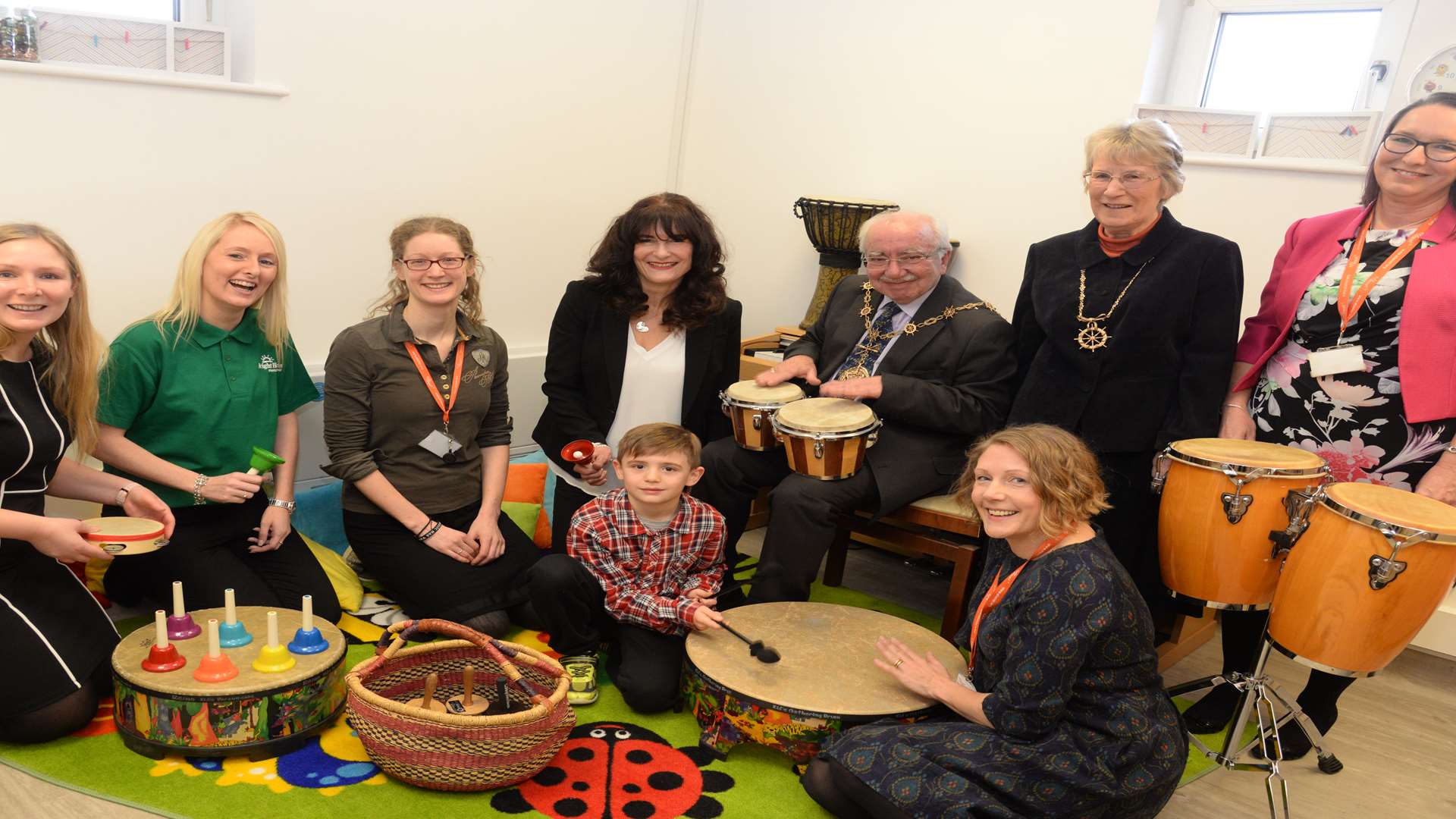 Mayor Harold Craske with the team behind the new room and some of the patients