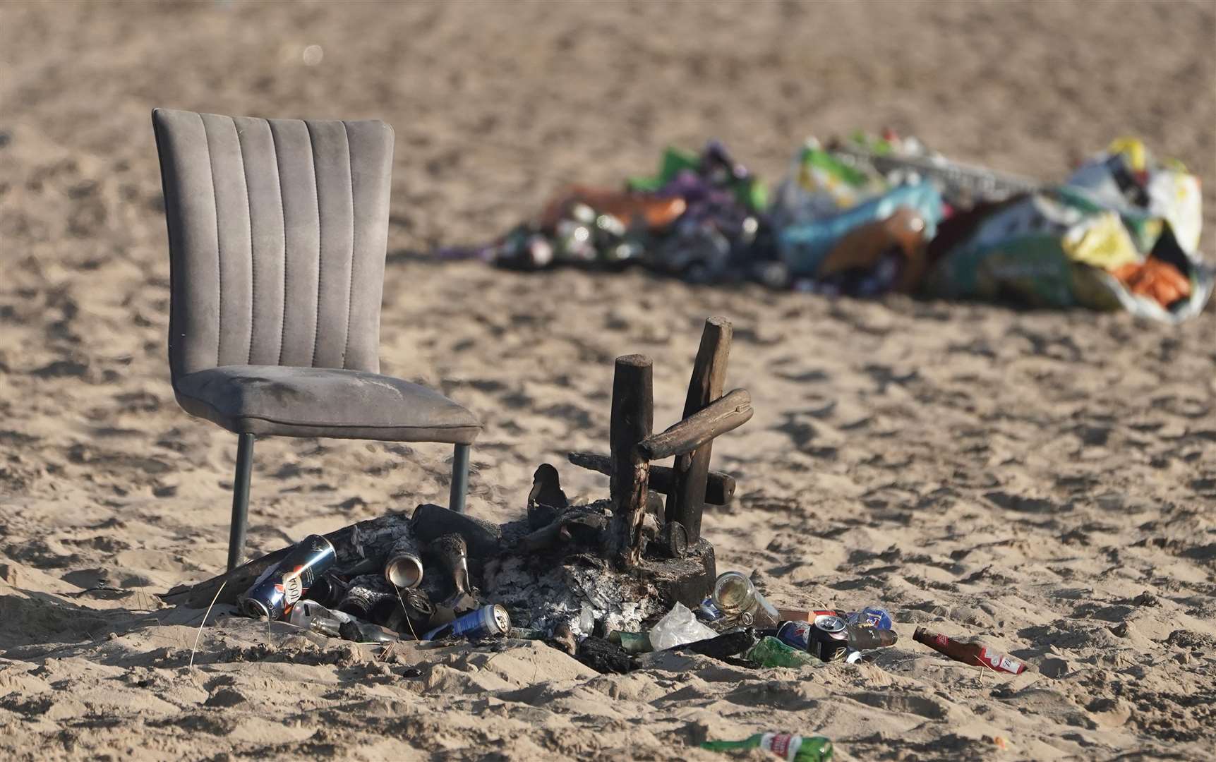 A discarded chair next to a burnt-out barbecue on Tynemouth beach (Owen Humphreys/PA)