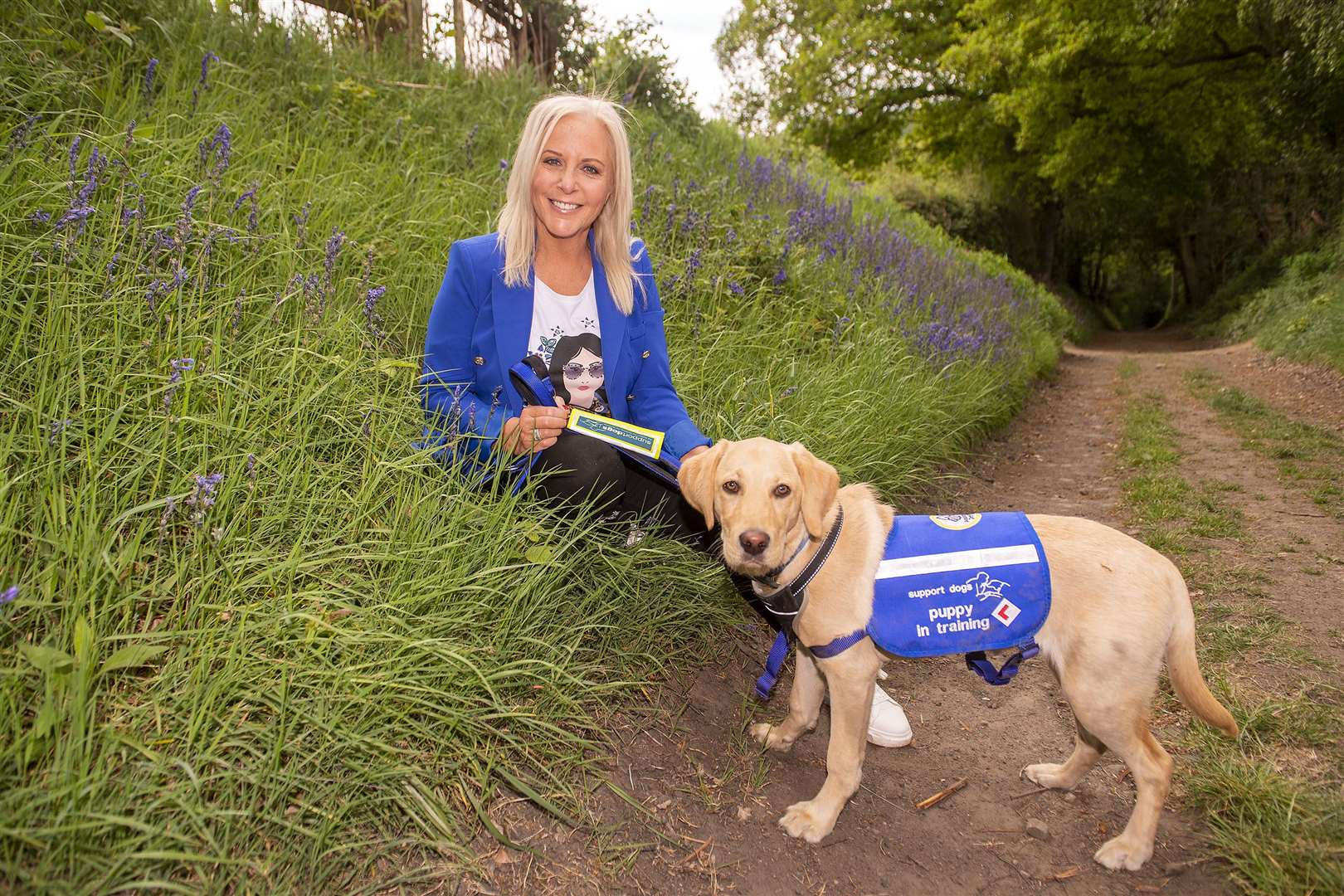 Deana Sampson with six-month-old golden Labrador Regis (Anthony Devlin/PA)