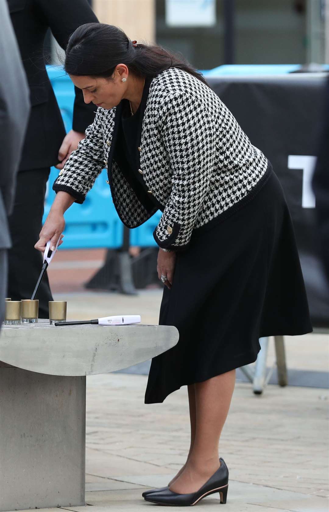 Home Secretary Priti Patel lights a candle (Steve Parsons/PA)