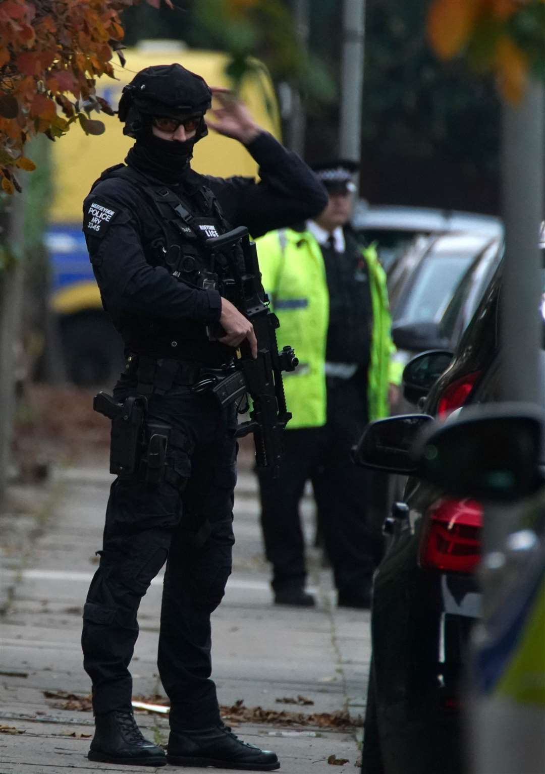 Armed police at a cordoned-off address hours after the explosion (Peter Byrne/PA)