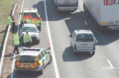 Police at the scene with the damaged car. Picture: MATT MATTHEW