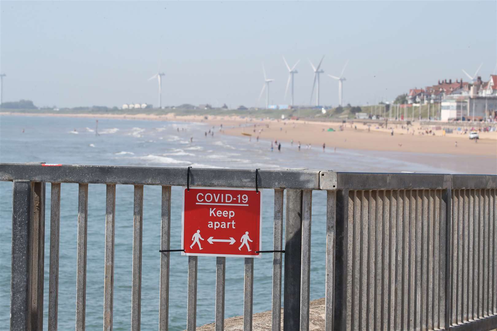 Bridlington sunseekers were reminded to keep their distance from others (Danny Lawson/PA)