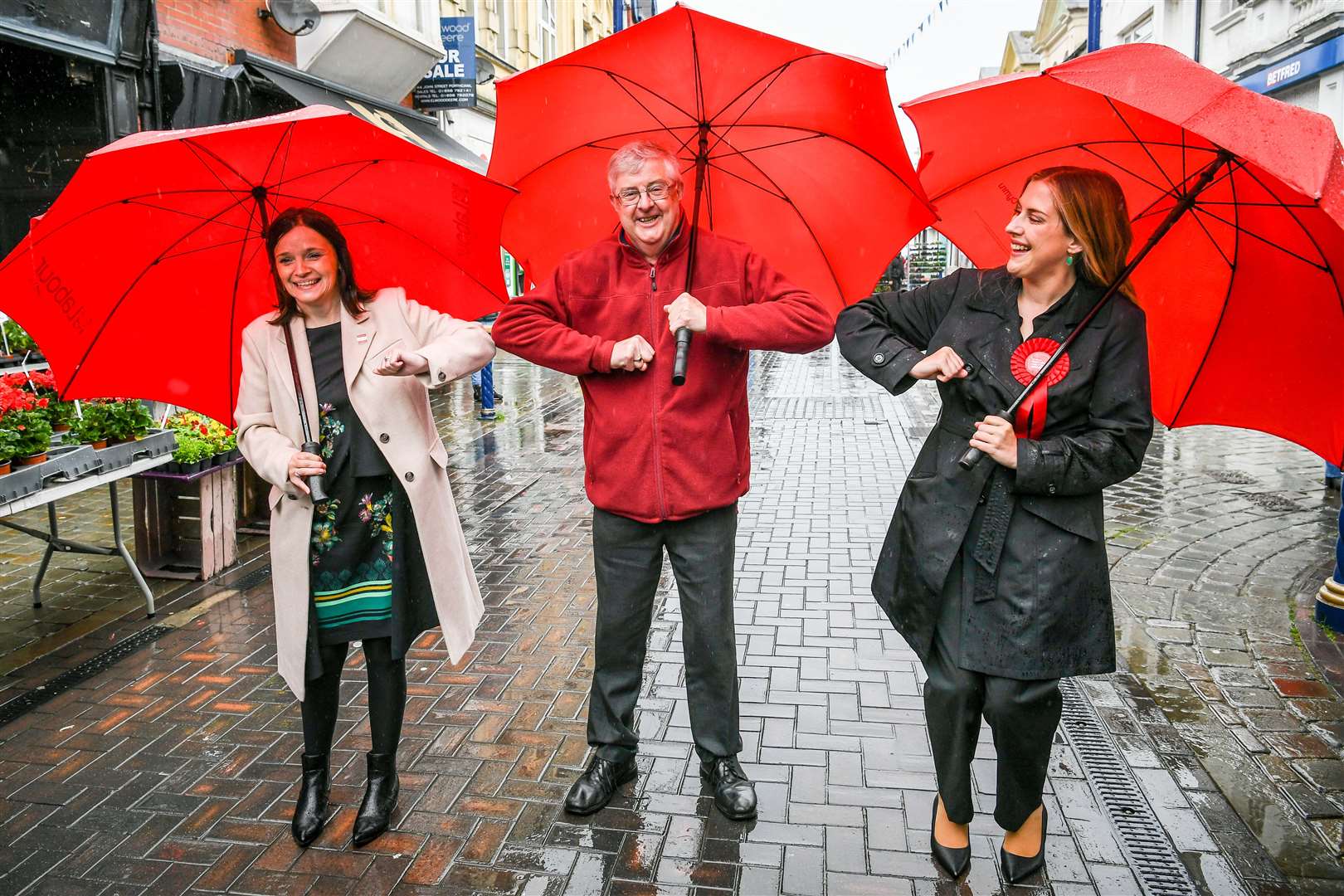 Wales First Minister Mark Drakeford elbow bumps newly-elected MS Labour candidates Elizabeth Buffy Williams, Rhondda, left, and Sarah Murphy, Bridgend & Porthcawl, right, as they meet in Porthcawl (Ben Birchall/PA)