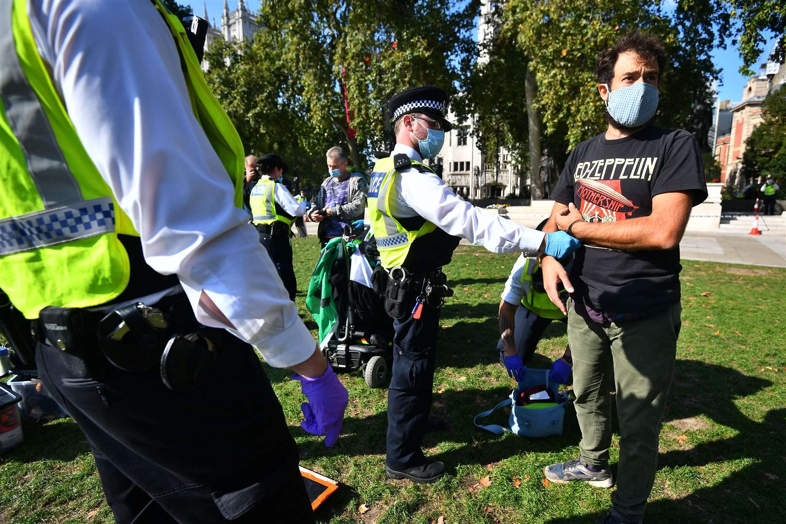 Police detain two Extinction Rebellion protesters in Parliament Square (Victoria Jones/PA)