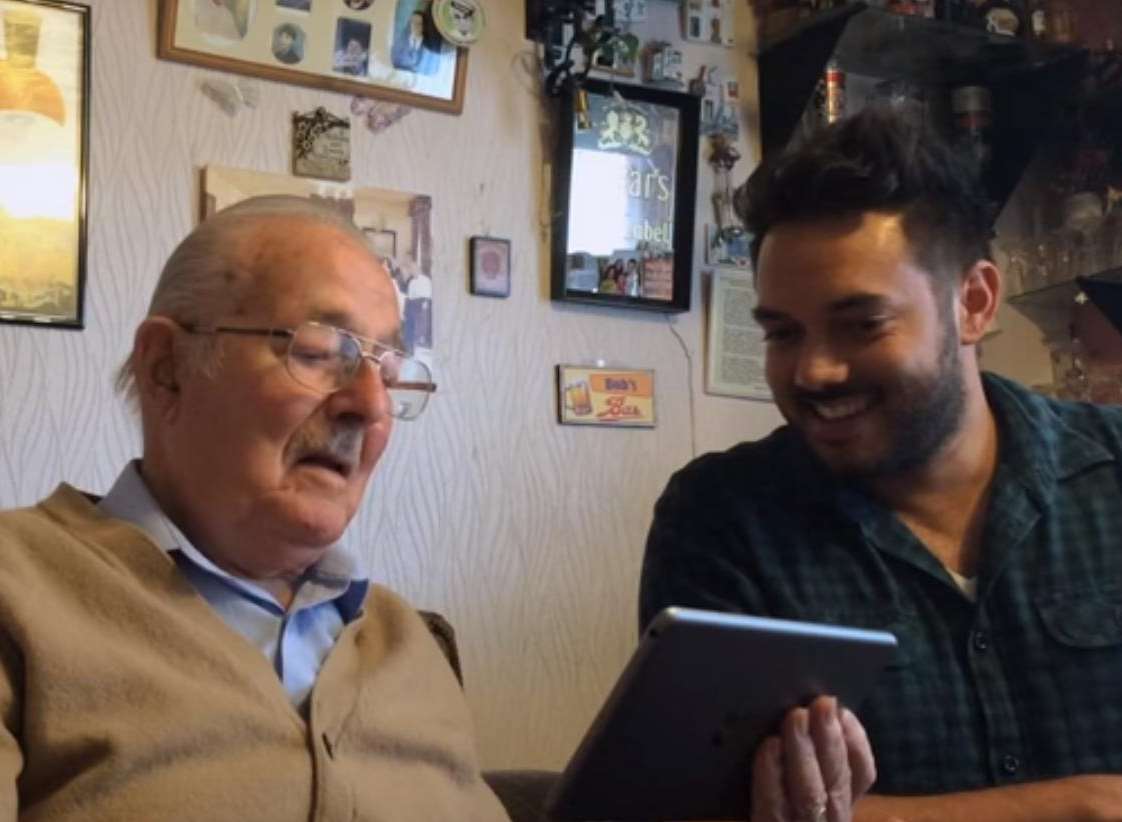 Grandson Gary Rolf shows his grandad Bob how to use the app at his Rochester home