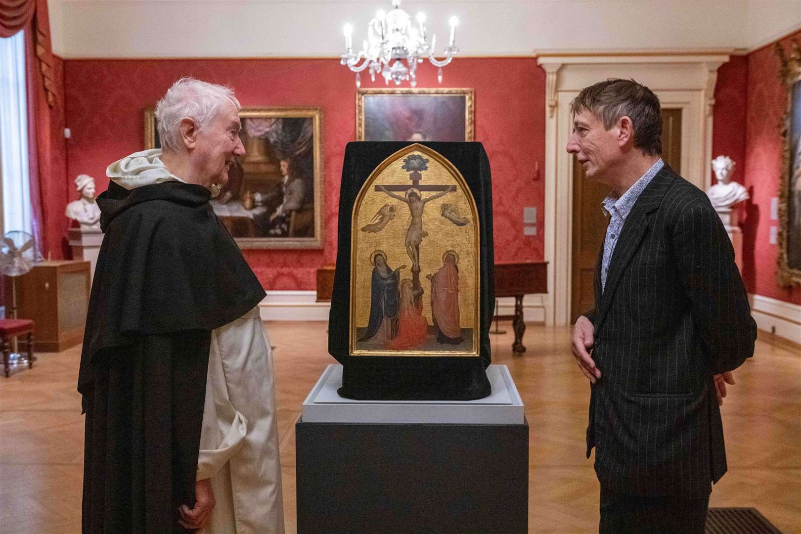 Fr Timothy Radcliffe and the director of the Ashmolean, Dr Xa Sturgis, alongside Fra Angelico’s The Crucifixion (Jas Lehal Media Assignments/PA)