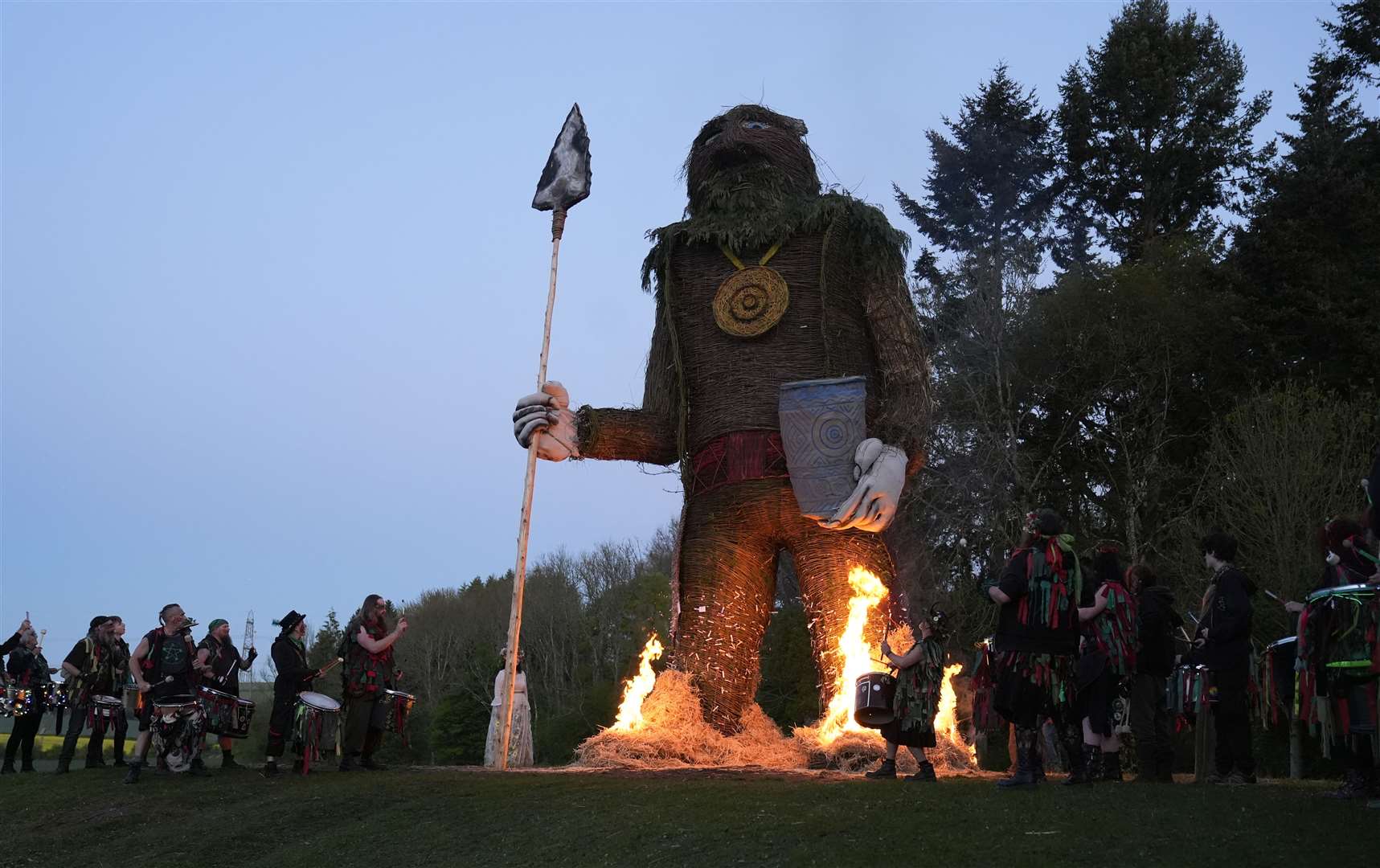 Members of the Pentacle Drummers perform in front of a burning wicker man (Andrew Matthews/PA)