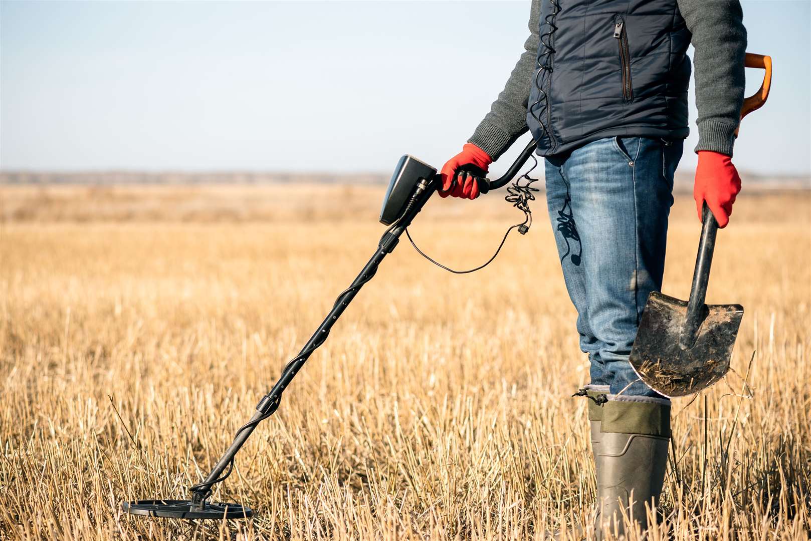 Treasure hunter with a metal detector. Stock photo