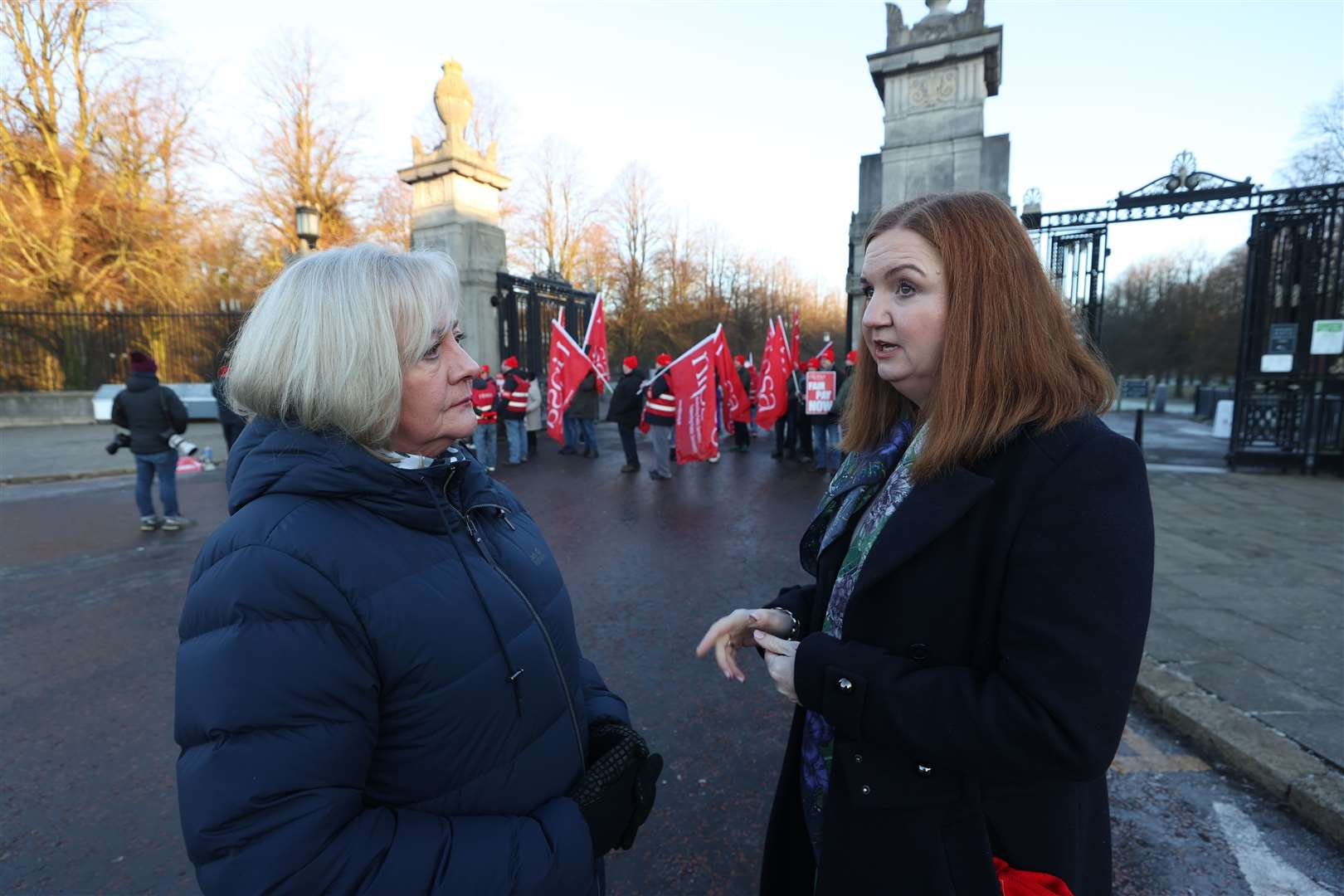 General secretary of Northern Ireland Public Service Alliance (Nipsa), Carmel Gates (left), speaking with head of the NI Civil Service Jayne Brady on the picket line outside the gates of the Stormont Estate (Liam McBurney/PA)