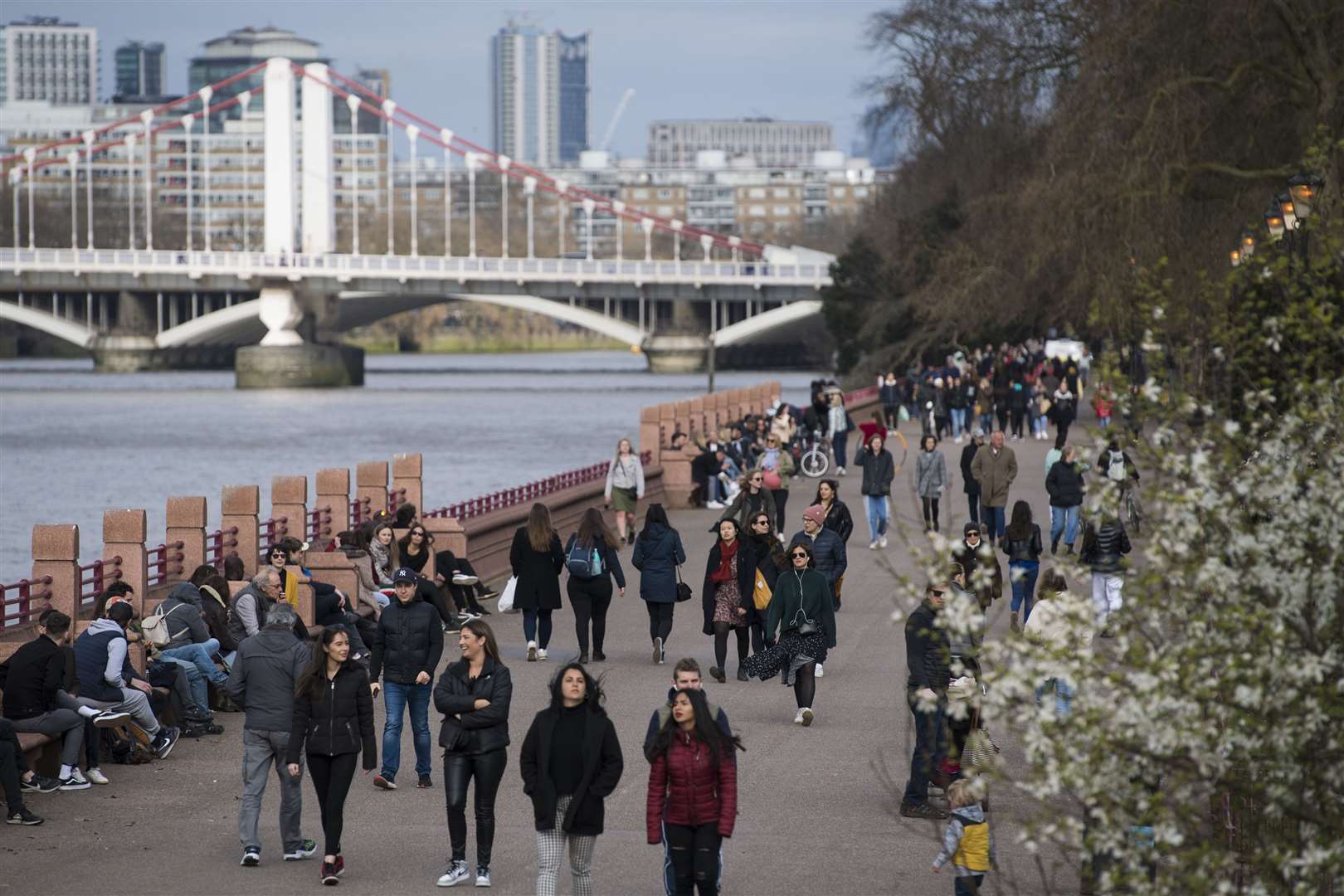 People walk alongside the River Thames in Battersea Park (Kirsty O’Connor/PA)